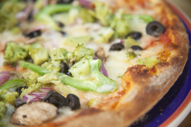 Fresh vegetable pizza with melted cheese at State Street Grill